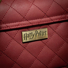 Load image into Gallery viewer, Metal Harry Potter Badge detailing on the red quilted Gryffindor Trunk Bag 