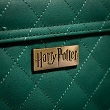 Load image into Gallery viewer, Harry Potter Metal Badge Detailing on the Quilted Material of the Slytherin Trunk Bag