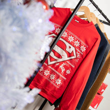 Load image into Gallery viewer, Christmas Tree with Superman Christmas Jumper in Background on Clothing Rack